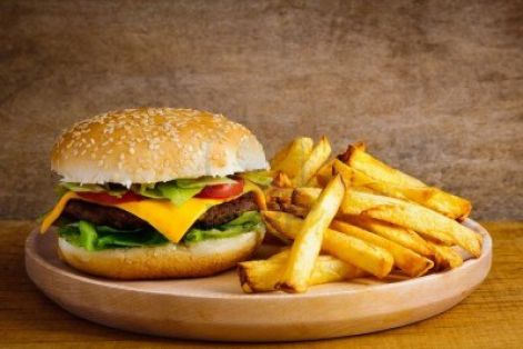 13968864-fast-food-hamburger-and-french-fries-on-a-wooden-plate.jpg